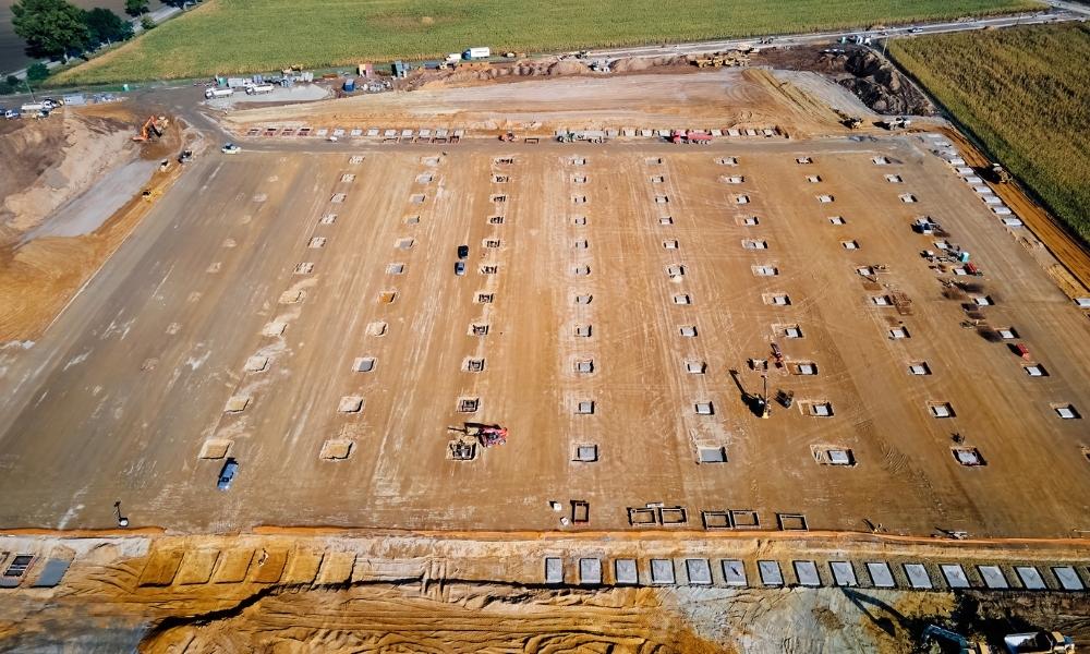 LiDAR mapping aerial view of a construction site showing graded soil, foundation layout points, and earthwork preparation for development planning