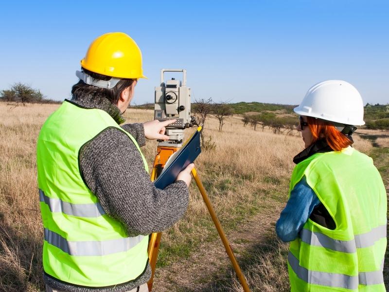 Licensed surveyor reviewing property boundaries and easement documents before recording a new easement in Miami Florida
