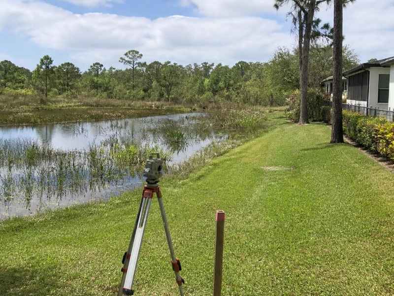 wetland buffer boundary survey miami fl | Miami Land Surveying Construction surveyor using a total station at a phased residential development site in Miami, Florida.